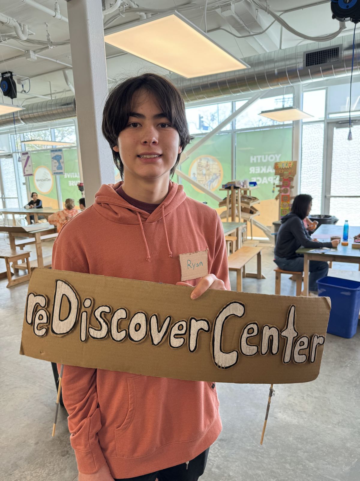 Holding a reDiscover Center sign